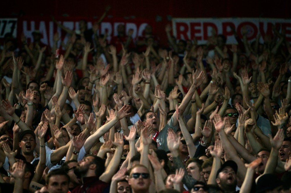 Bayern Munichs supporters cheer before a football match in Athens on September 16, 2015