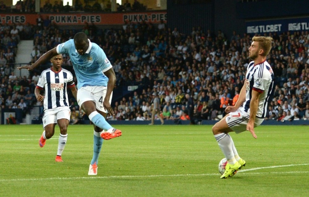 Manchester Citys Yaya Toure (L) scores from a deflection during their English Premier League match against West Bromwich Albion, at The Hawthorns in West Bromwich, central England, on August 10, 2015