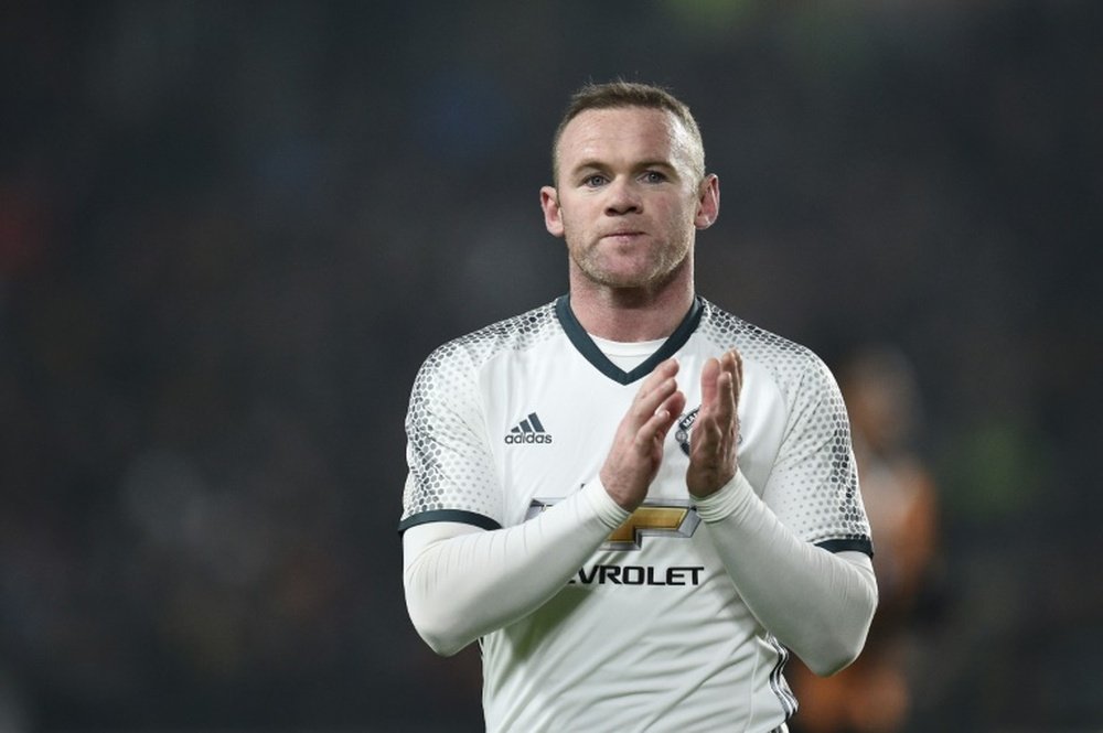 Rooney applauding on the pitch. AFP