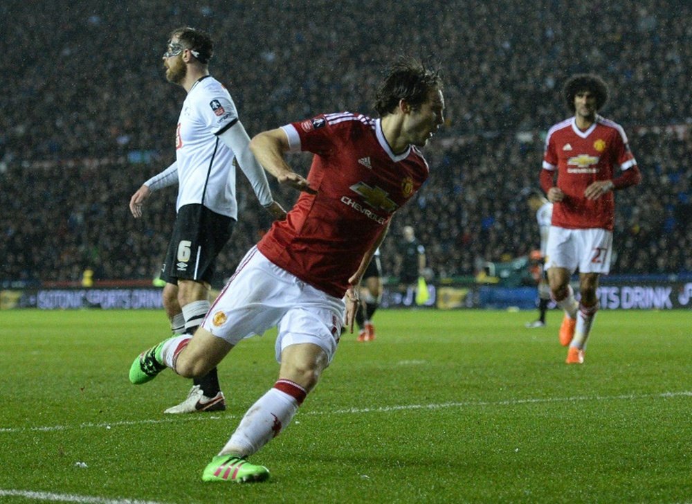 Manchester Uniteds midfielder Daley Blind (C) celebrates scoring his teams second goal during the FA cup fourth round football match between Derby County and Manchester United at Pride Park stadium in Derby on January 29, 2016