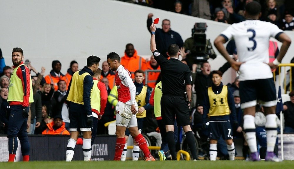 Referee Michael Oliver shows a red card to Arsenals French midfielder Francis Coquelin during a match between Tottenham Hotspur and Arsenal in London on March 5, 2016