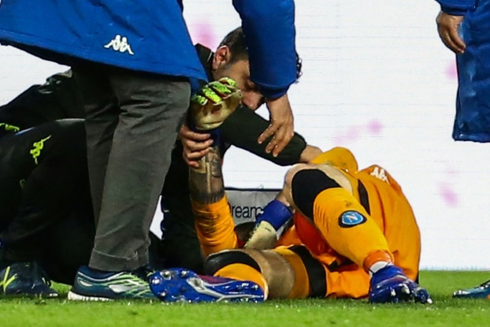 Medics tend to Ospina after head injury. AFP