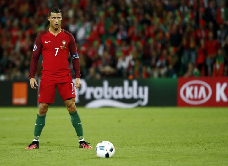 Portugals forward Cristiano Ronaldo prepares for a free kick during the Euro 2016 match between Portugal and Iceland in Saint-Etienne on June 14, 2016