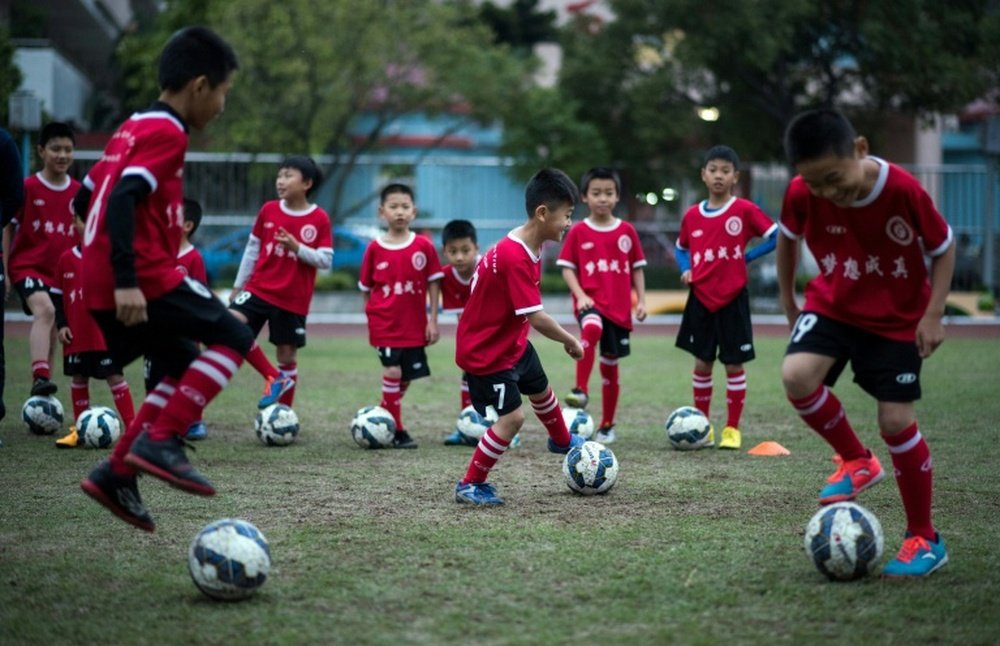 Children attend a football training session in the suburbs of Guangzhou in southern Chinas Guangdong province