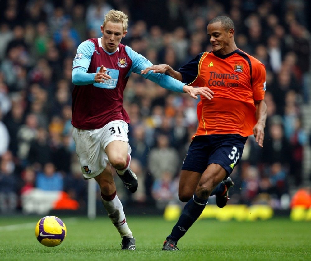 West Ham Uniteds Jack Collison (left) is challenged by Manchester Citys Belgium player Vincent Kompany during their Premier League match at Upton Park in London on March 1, 2009