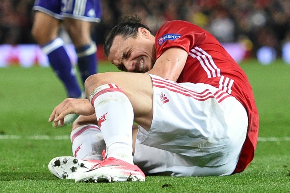 Manchester Uniteds striker Zlatan Ibrahimovic reacts after falling awkwardly
