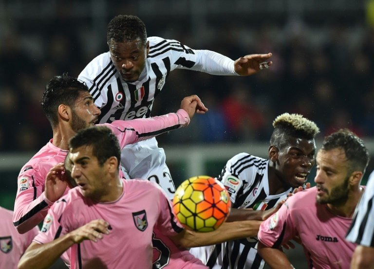 Juventus Patrice Evra (top) and Paul Pogba (2nd R) fights for the ball with Palermos defenders during their Italian Serie A match, at the Renzo Barbera stadium in Palermo, on November 29, 2015