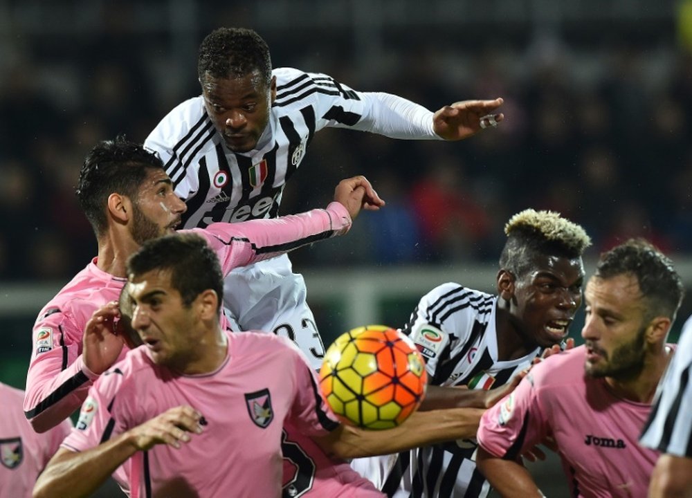 Juventus Patrice Evra (top) and Paul Pogba (2nd R) fights for the ball with Palermos defenders during their Italian Serie A match, at the Renzo Barbera stadium in Palermo, on November 29, 2015