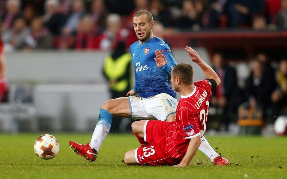 Arsenal's Jack Wilshere and Cologne's Matthias Lehmann challenge for the ball in Germany. AFP