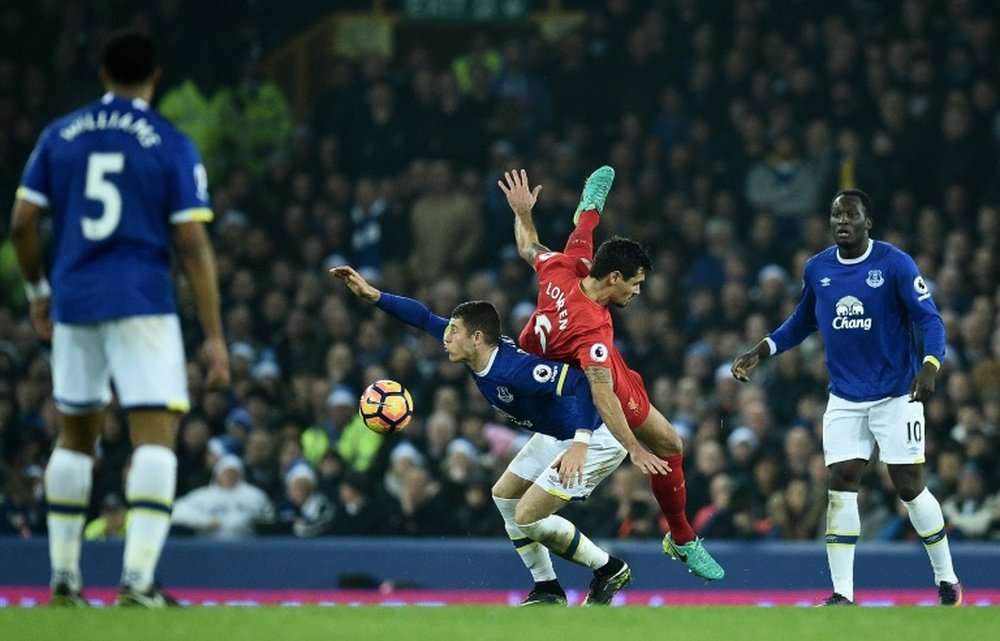 Lovren is challenged by Ross Barkley in the Merseyside derby. AFP