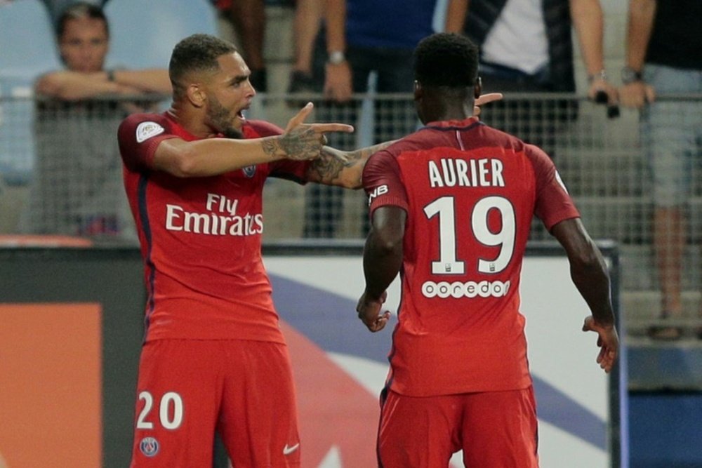 Paris Saint-Germains defender Layvin Kurzawa (L) celebrates with teammate Serge Aurier (R) after scoring a goal during the match against Bastia on August 12, 2016