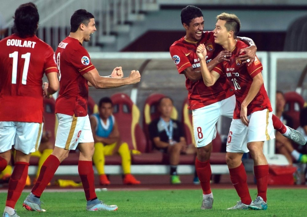 Guangzhou Evergrandes Huang Bowen (R) celebrates with teammates after scoring against Japans Kashiwa Reysol during their AFC Champions League quarterfinal match at the Tianhe Sport Center in Guangzhou on September 15, 2015