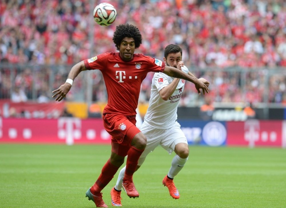 Bayern Munichs Brazilian defender Dante (left) and Mainzs midfielder Yunus Malli vie for the ball during their Bundesliga match at the Allianz Arena in Munich, southern Germany on May 23, 2015