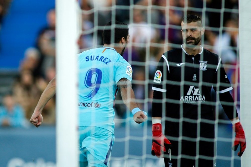 Suarez was booked for impeding Cuellar. AFP