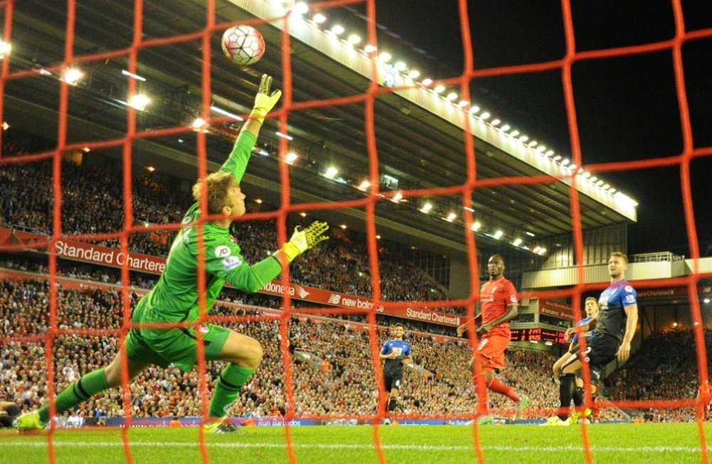 Bournemouths goalkeeper Artur Boruc (L) saves a shot from Liverpools Christian Benteke (3rd R) during the English Premier League match at the Anfield stadium in Liverpool on August 17, 2015