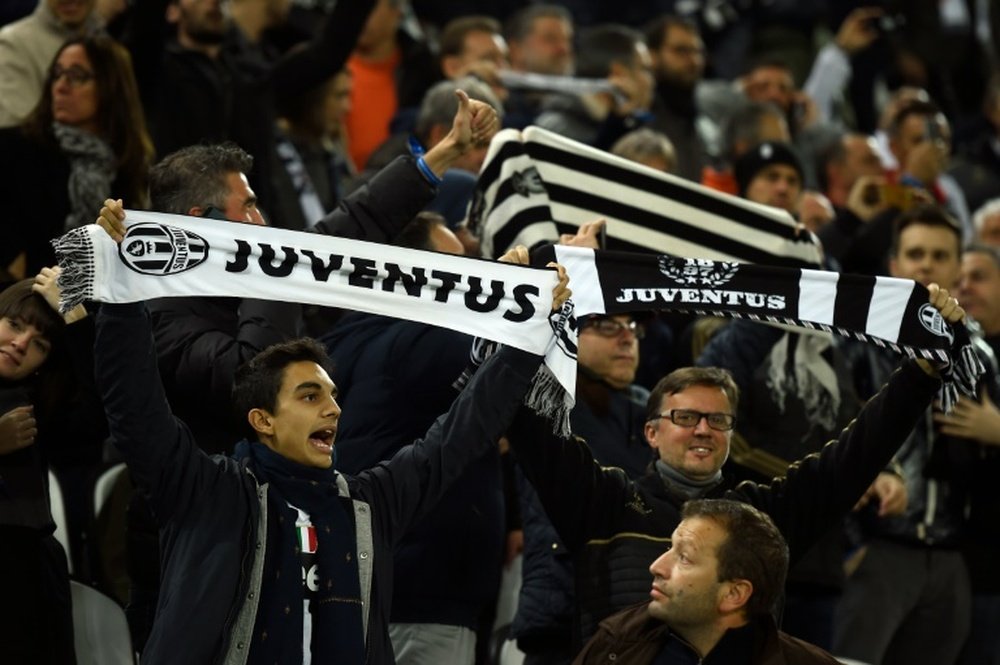 Juventus fans cheer before a match on October 21, 2015 at the Juventus stadium in Turin