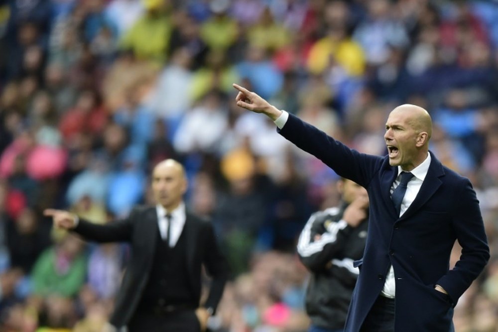 Real Madrids coach Zinedine Zidane gestures during the Spanish league match Real Madrid CF vs Valencia CF in Madrid on May 8, 2016