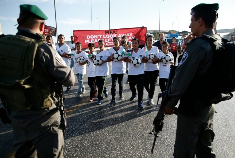 Palestinian youths wanting to play football in the Maale Adumim settlement in the Israeli occupied West Bank are blocked by Israeli security forces on October 11, 2016