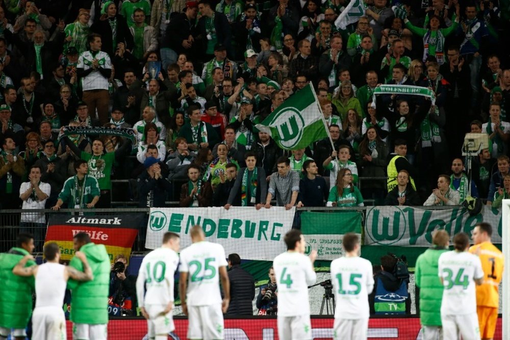 Wolfsburgs players celebrate with the fans after the UEFA Champions League quarter-final, first-leg football match against Real Madrid on April 6, 2016 in Wolfsburg, northern Germany