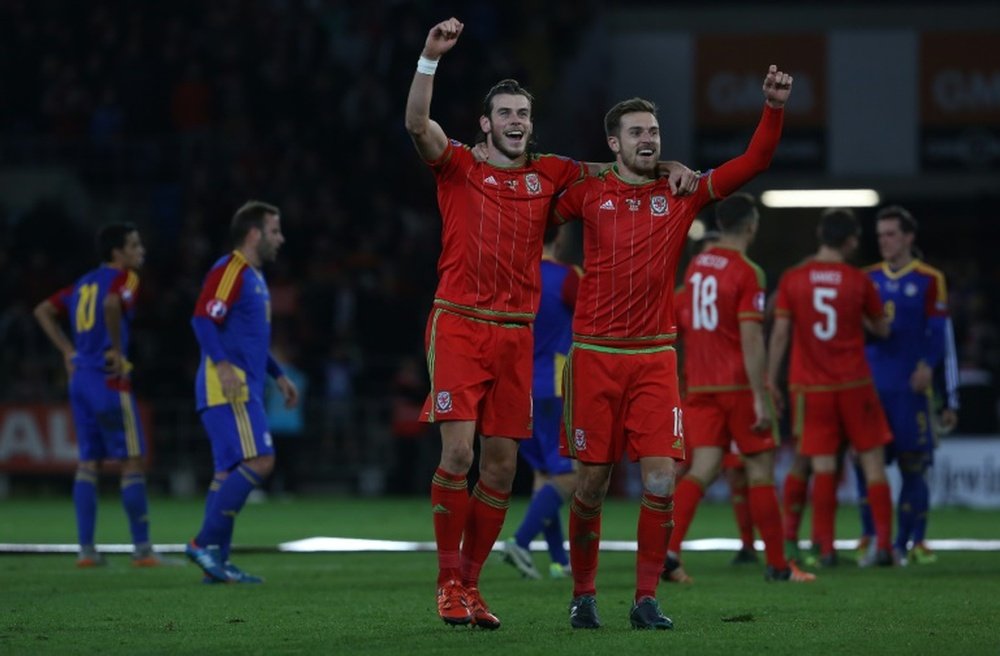 Waless midfielder Gareth Bale (L) and Waless midfielder Aaron Ramsey celebrate following Euro 2016 qualifying football match between Wales and Andorra at Cardiff City stadium in Cardiff, south Wales, on October 13, 2015