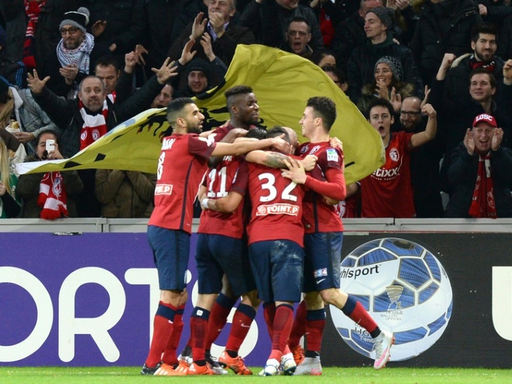 Lilles midfielder Eric Bautheac is congratulated by a teammates after scoring a goal during the French League Cup football match Lille versus Bordeaux at the Stade Pierre Mauroy stadium in Villeneuve-dAscq, France, on January 26, 2016