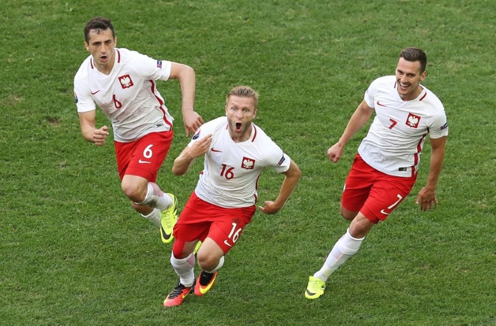 Polands midfielder Jakub Blaszczykowski (C) celebrates after scoring against Ukraine. BeSoccer