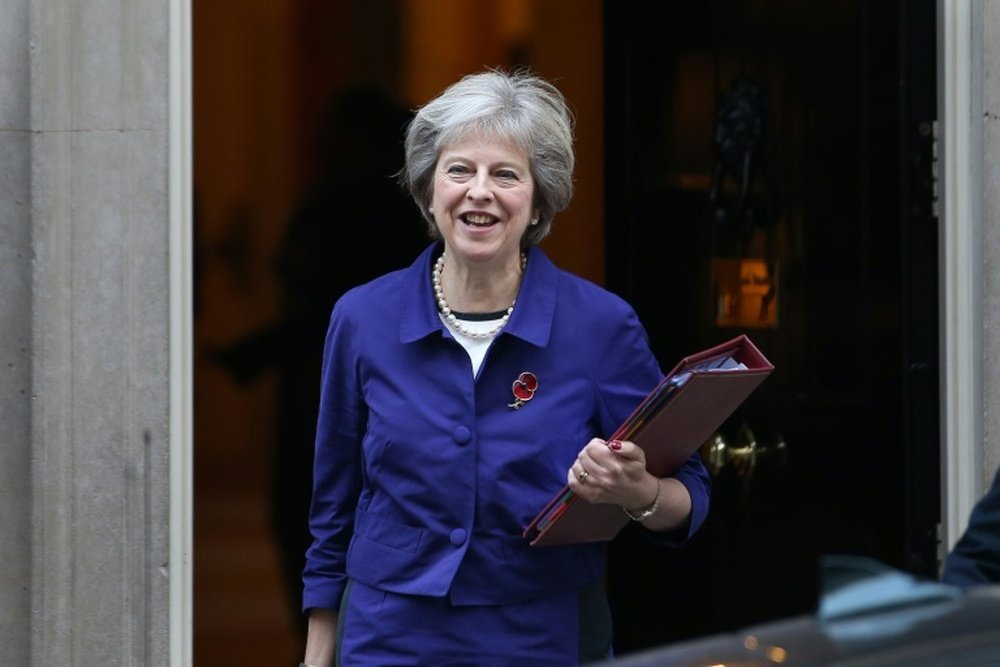 Theresa May wears a poppy as she leaves 10 Downing Street on November 2. AFP