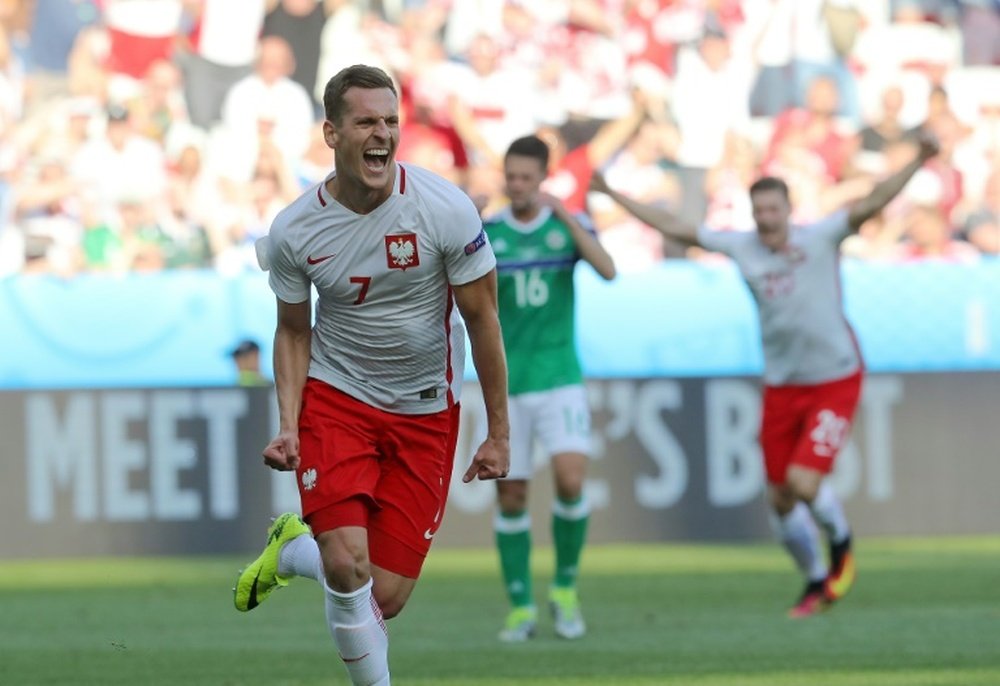Polands forward Arkadiusz Milik (C) celebrates his goal during the Euro 2016 match between Poland and Northern on June 12, 2016