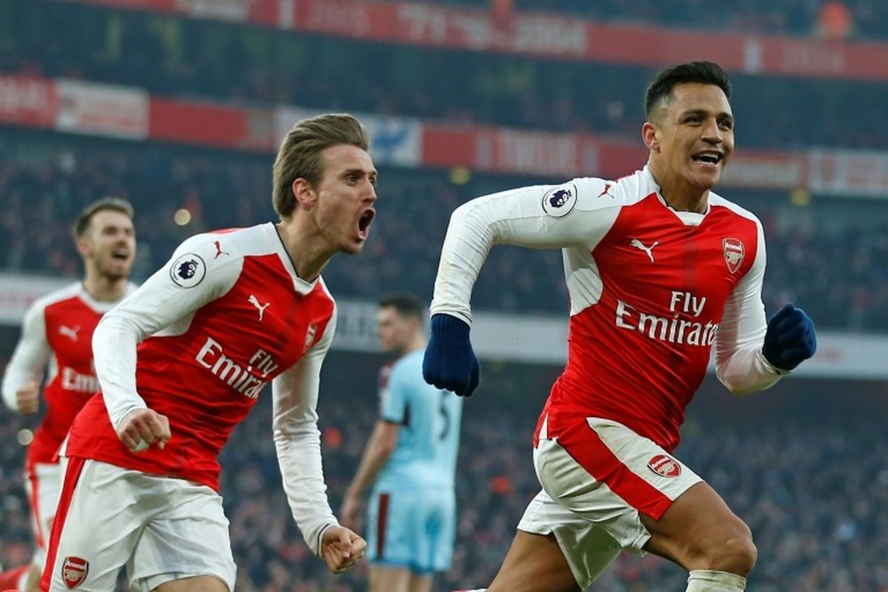 Arsenal striker Alexis Sanchez (R) celebrates with teammate Nacho Monreal. AFP