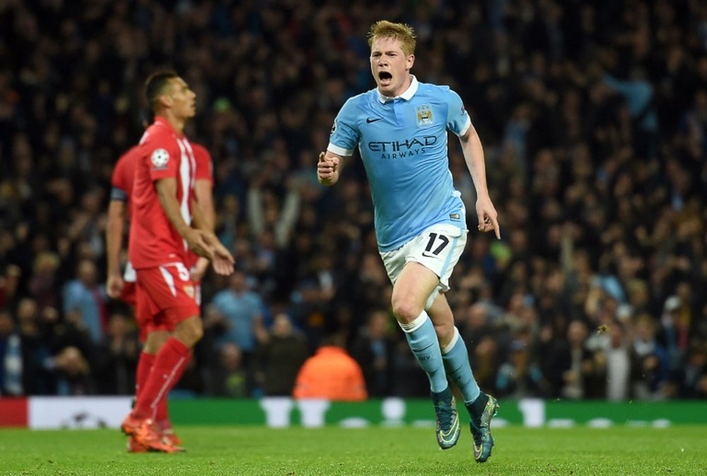 Manchester Citys midfielder Kevin De Bruyne (R) celebrates after scoring during a UEFA Champions league Group D football match against Sevilla in Manchester on October 21, 2015