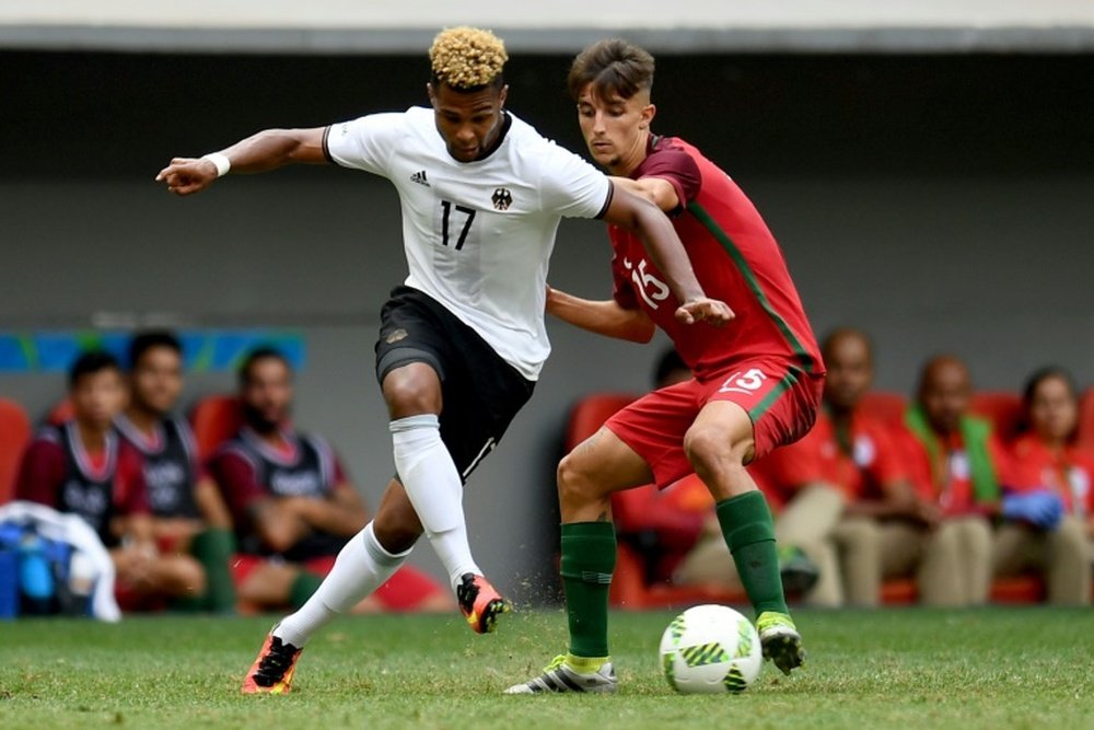 Serge Gnabry (left) fends off Portugals Fernando in Brasilia on August 13, 2016