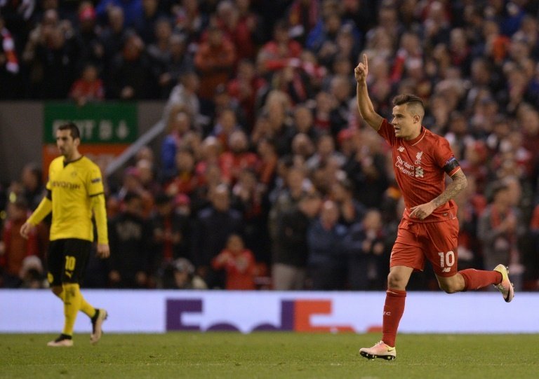 Liverpool's midfielder Philippe Coutinho (R) celebrates after scoring. AFP