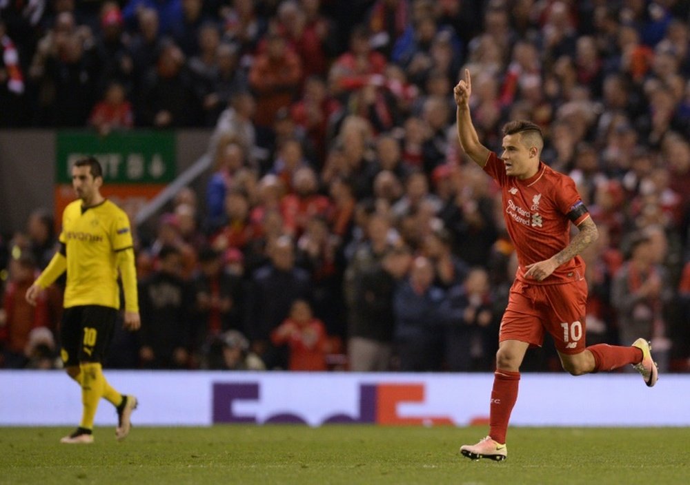 Liverpool's midfielder Philippe Coutinho (R) celebrates after scoring. AFP