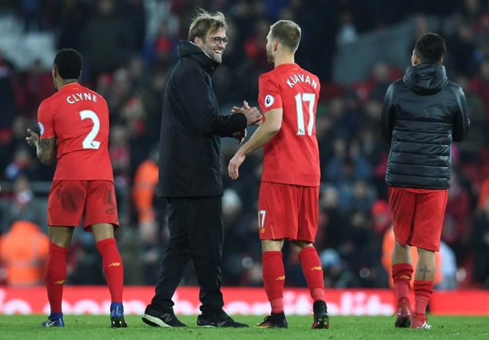 Liverpool's German manager Jurgen Klopp shakes hands with defender Ragnar Klavan. AFP