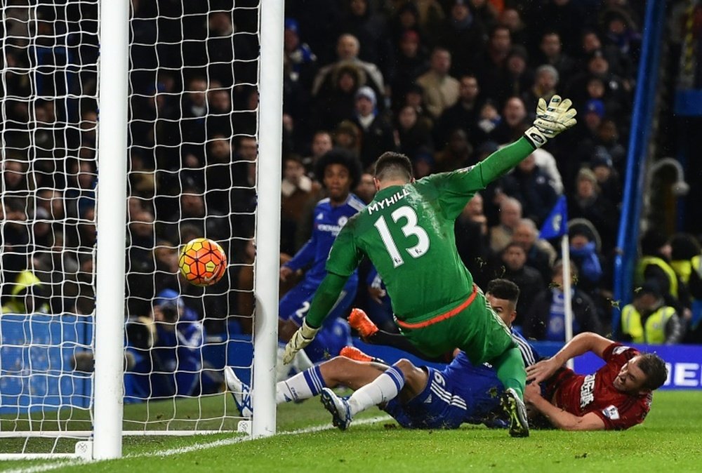 West Bromwich Albions defender Gareth McAuley (R) bundles the ball into his own net under pressure from Chelseas striker Kenedy, past goalkeeper Boaz Myhill on January 13, 2016