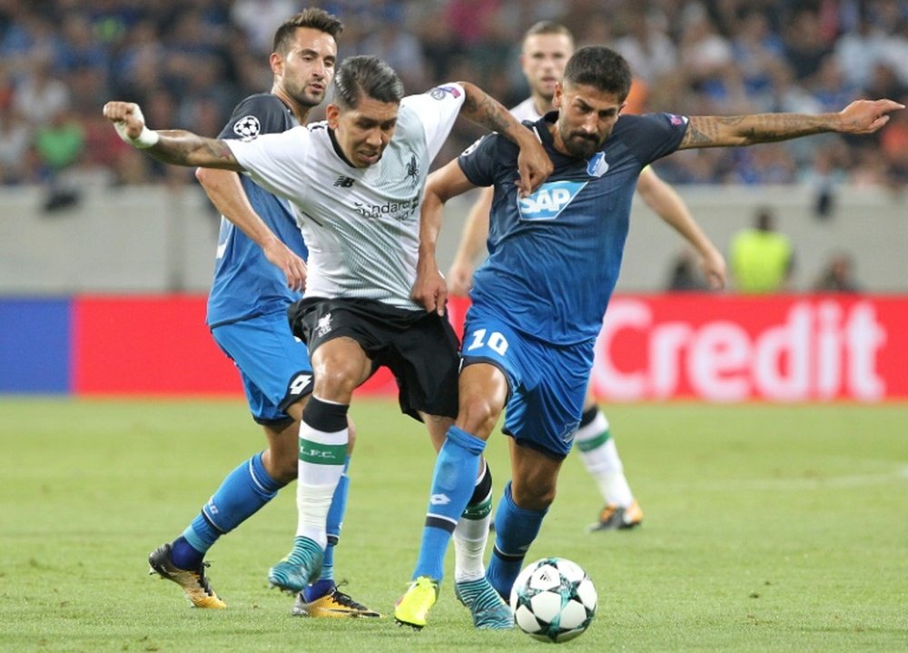 Demirbay challenges Firmino in the first leg. AFP