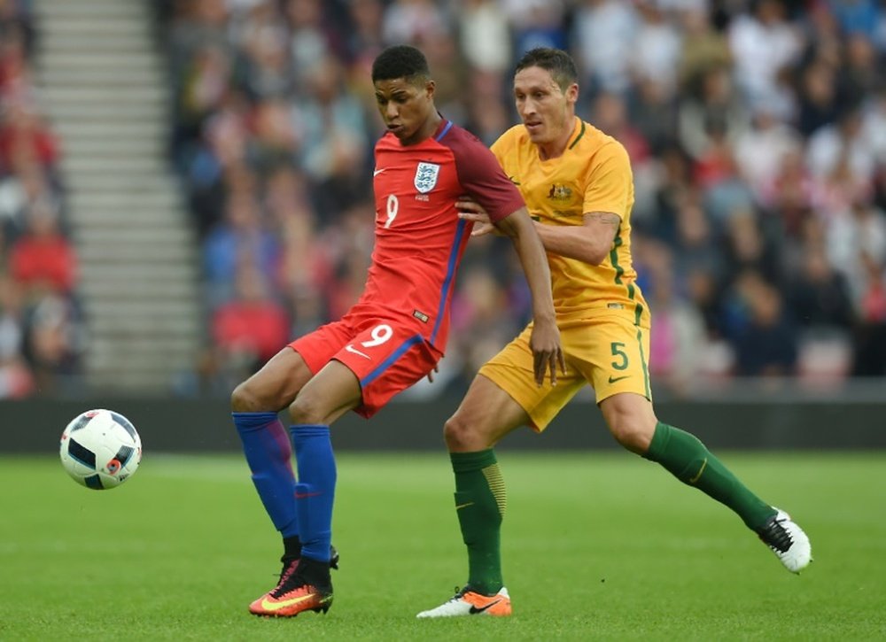 Englands striker Marcus Rashford (L) vies for the ball against Australias Mark Milligan during the friendly football match at the Stadium of Light in Sunderland, England, on May 27, 2016