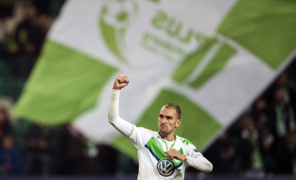 Wolfsburgs forward Bas Dost celebrates at the final whistle of the Group B, first-leg UEFA Champions League football match against Eindhoven on October 21, 2015