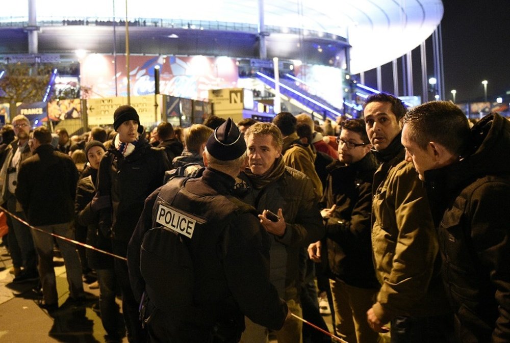 Football fans gather outside Stade de France stadium following the match against Germany on November 13, 2015, after a series of deadly attacks across the French capital