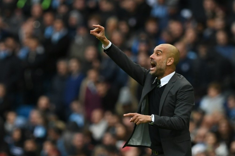 Guardiola shouts instructions to his players on the touchline. AFP