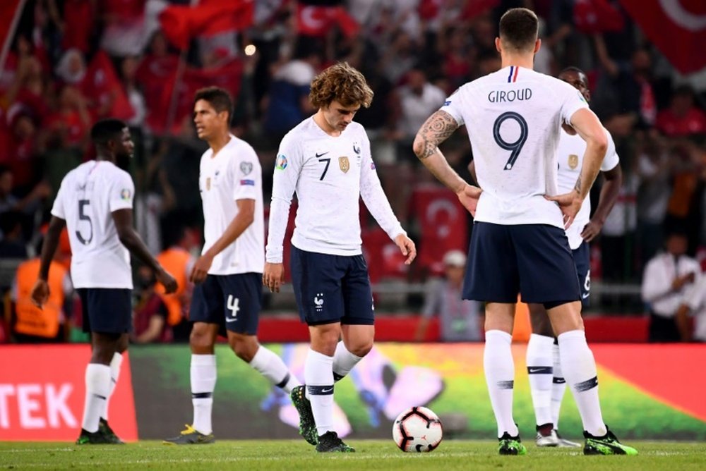 Antoine Griezmann and his France team mate look dejected following a poor defeat. AFP
