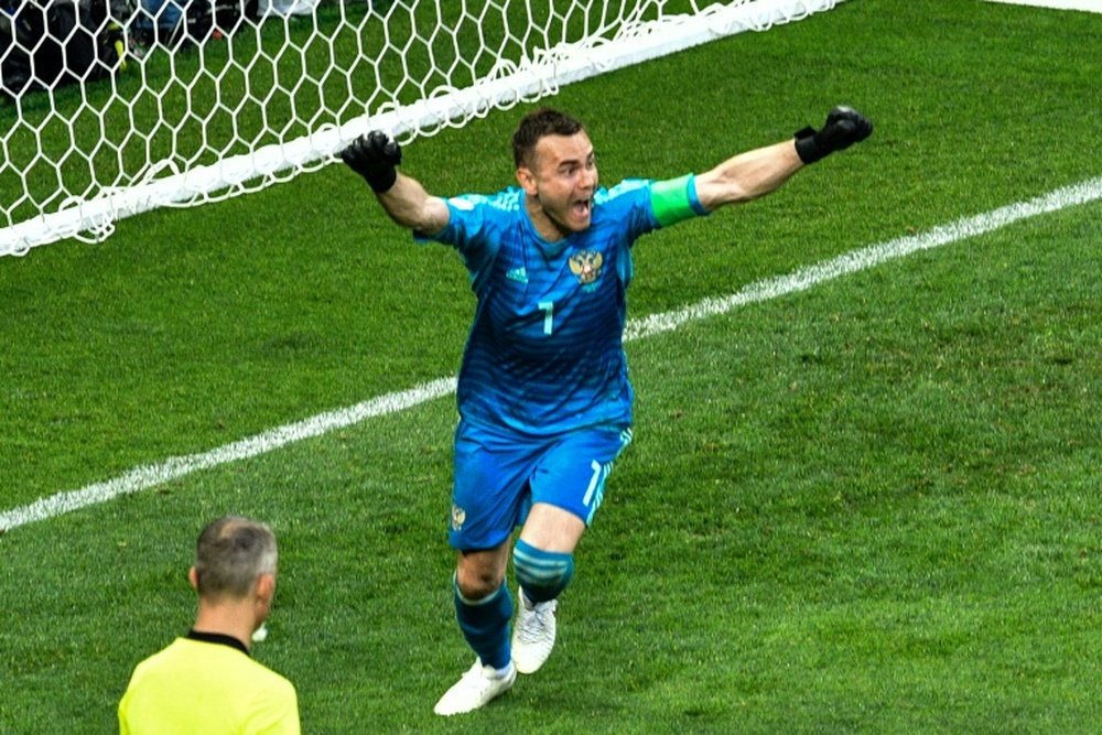 Akinfeev's heriocs put hosts Russia through to the next round at the expense of Spain. AFP