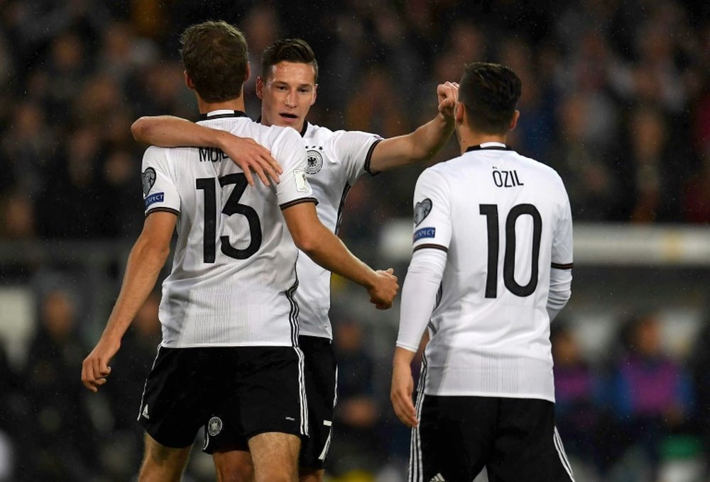 Muller, Ozil and Draxler celebrating a goal. AFP