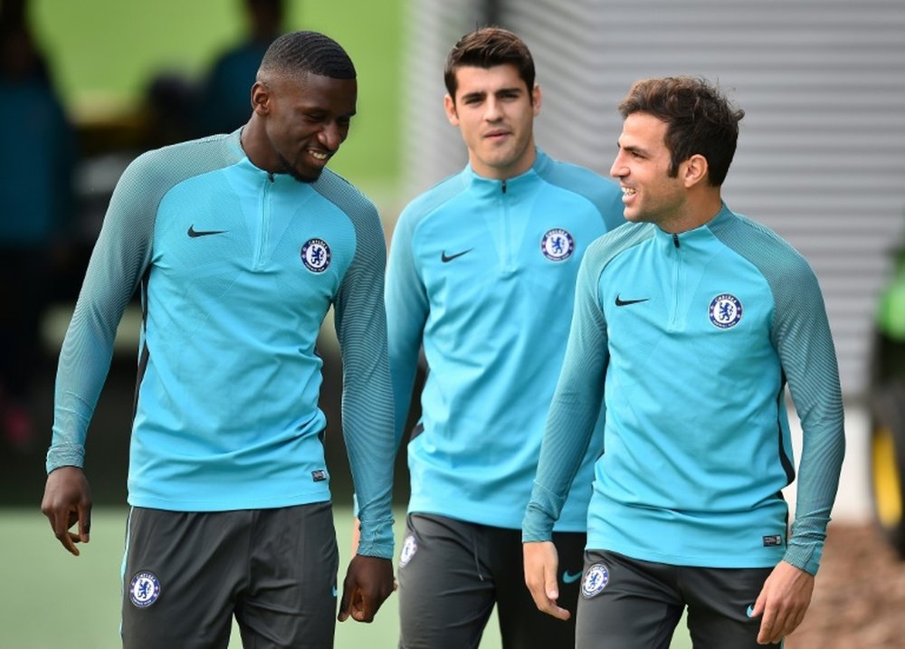 Fabregas has admitted that Chelsea are hoping Manchester City slip up. AFP