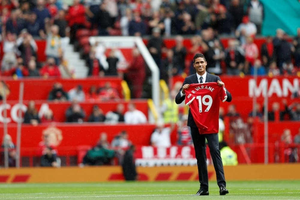 Varane will have to wear the number 19. AFP