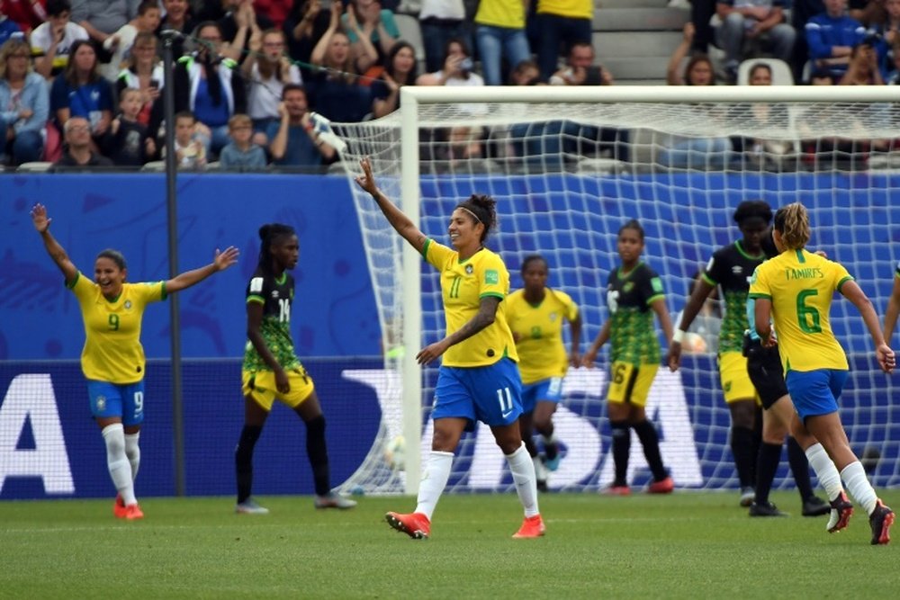 Cristiane marcou os três gols da vitória na estreia. AFP