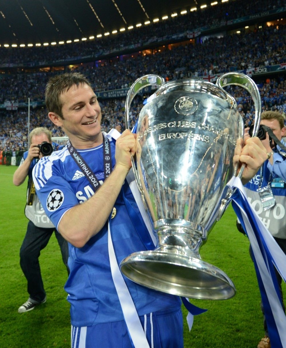 Frank Lampard holding up a Champions League trophy. AFP