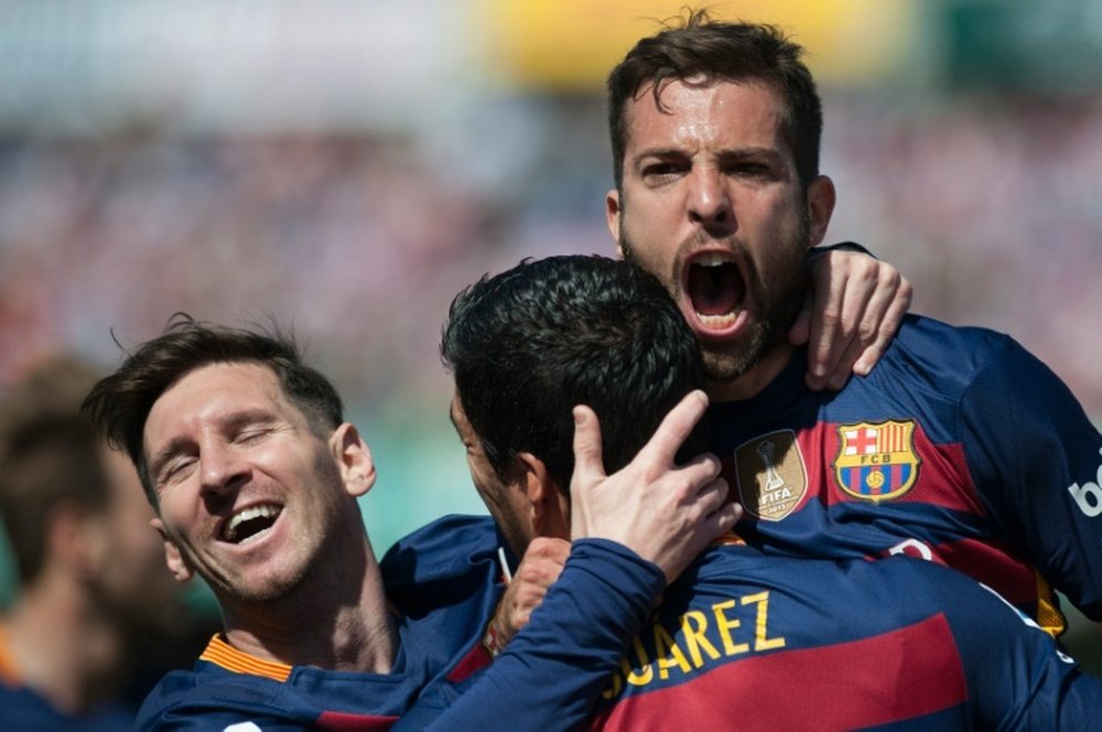 Jordi Alba et Lionel Messi congratulent Luis Suarez, auteur du triplé du Barça face à Grenade. AFP