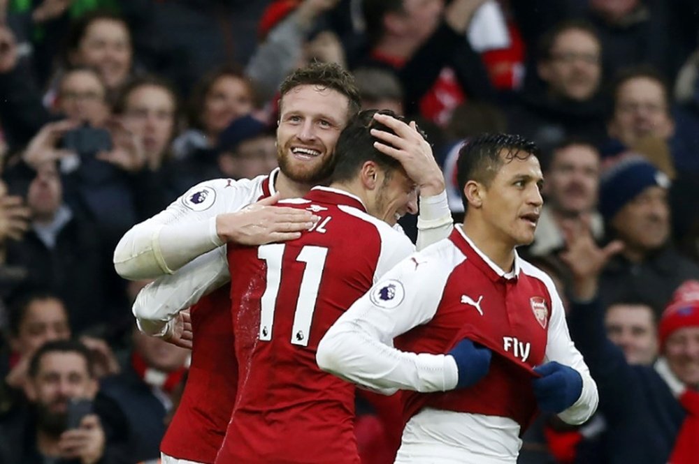 Ozil and Sanchez celebrate with Mustafi after his goal against Tottenham. AFP