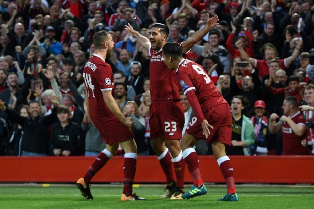 Emre Can (c) fête l'un de ses deux buts pour Liverpool. AFP